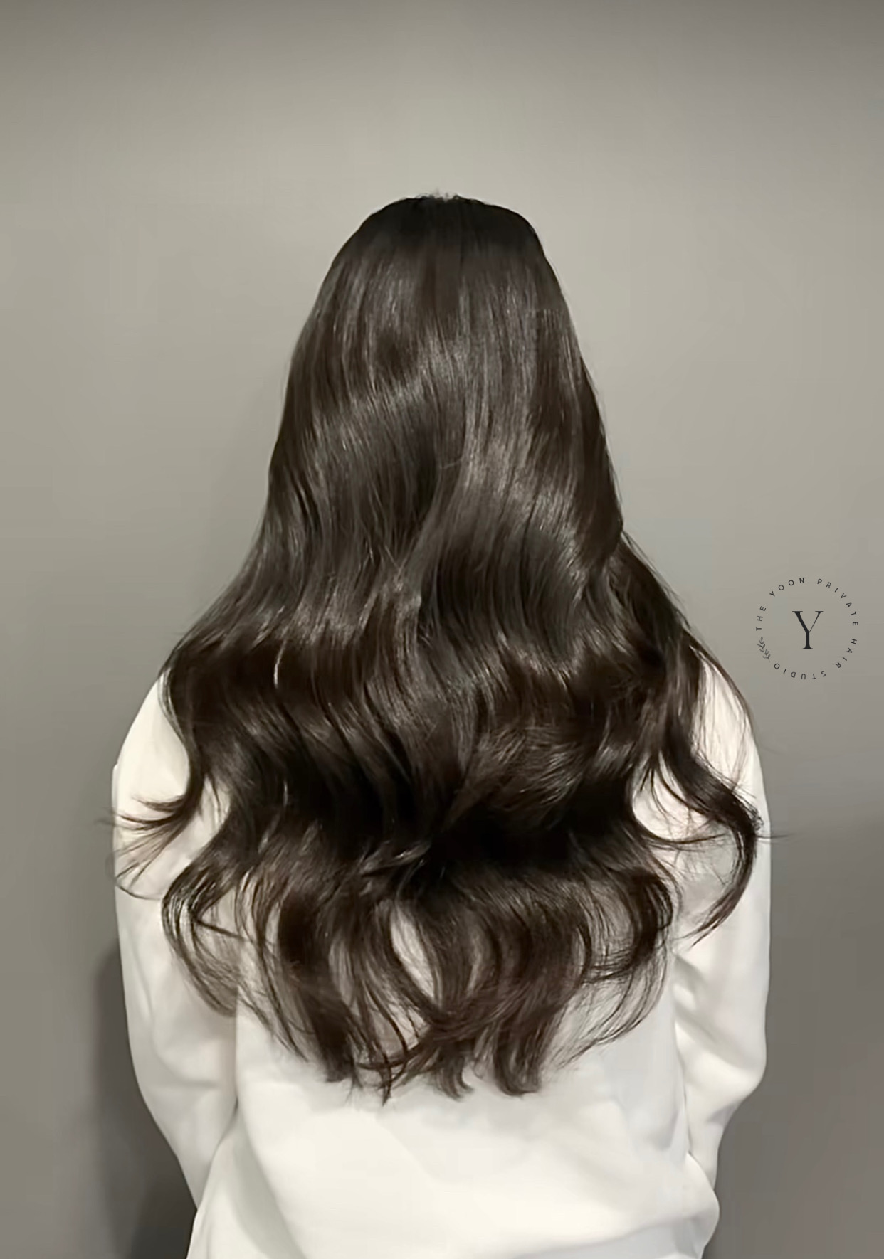 Long dark wavy hair, seen from behind